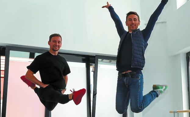 Iker Murillo salta con los brazos en alto junto a su marido, Vitali Safronkine, en su nuevo estudio.