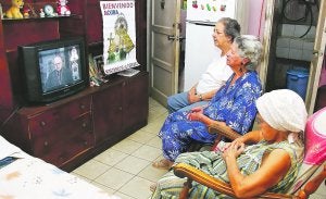 Tres mujeres católicas observan en la televisión la intervención del viernes del arzobispo de Santiago de Cuba, Dionisio García Ibáñez. ::
EFE/