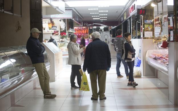 Varios clientes esperan su turno ante uno de los puestos de MercaIrun, en la mañana de ayer. / F. DE LA HERA