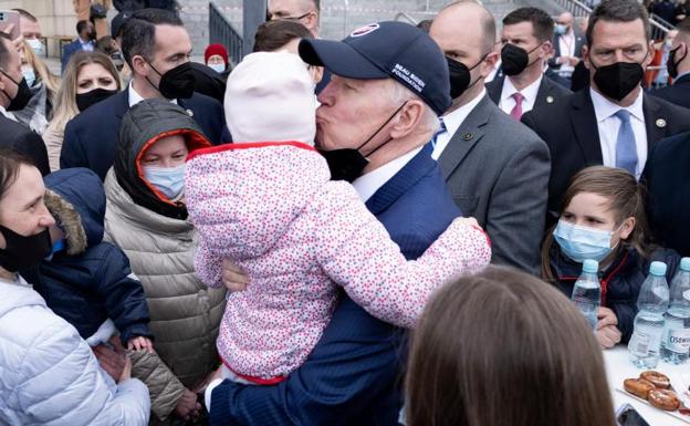 Biden hugs a girl during his visit to Warsaw, Poland.