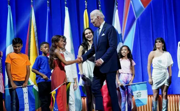 US President Joe Biden greets children at the summit.