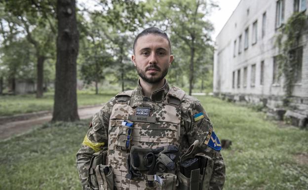 Popular singer Taras Topolia poses dressed in a camouflage uniform. 