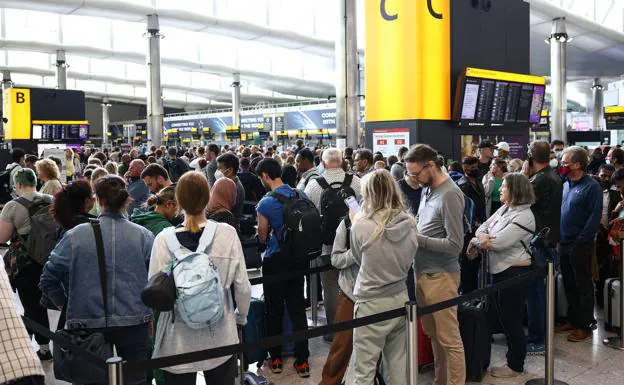 A crowd of passengers in one of the Heathrow airport terminals. 