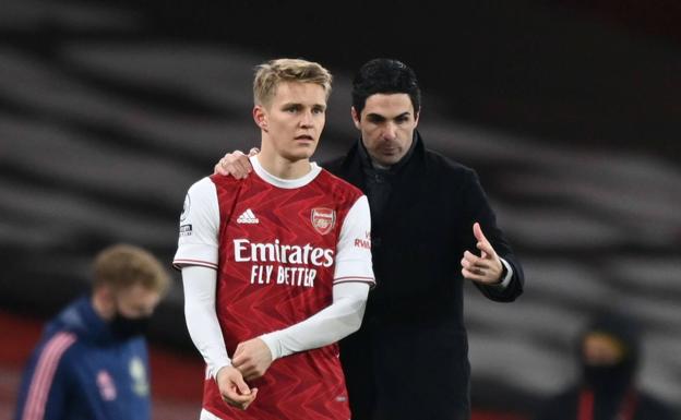 Mikel Arteta gives instructions to Odegaard before taking the field during a match in January 2021. 