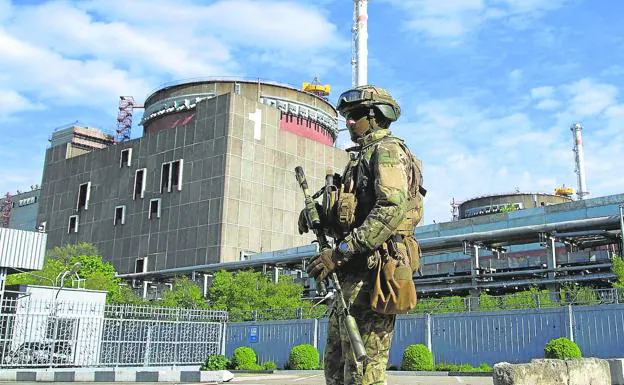 A Russian soldier patrols the surroundings of the nuclear plant