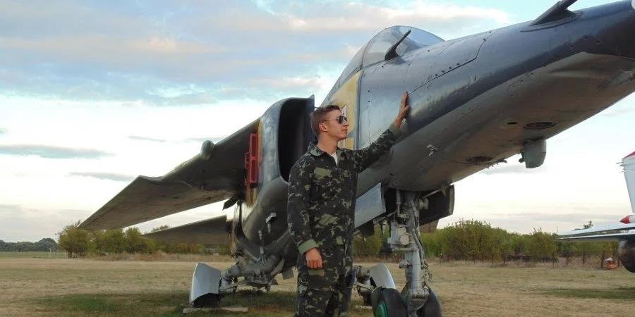 Anton Listopad poses next to his fighter plane