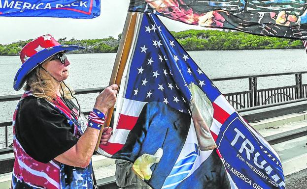 Supporters of Donald Trump gather near his residence at Mar-A-Lago in Palm Beach, Florida.