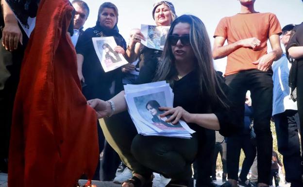 A young woman burns a hijab at a protest in the town of Sulaimaniya. 
