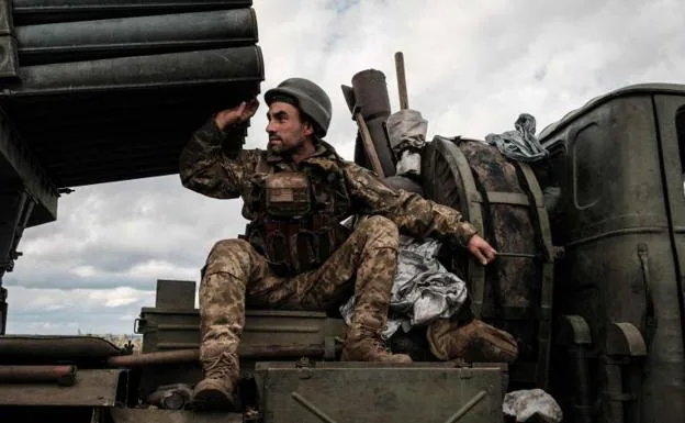 A Ukrainian soldier climbing into a BM-21 'Grad' multiple rocket launcher in Kharkiv. 