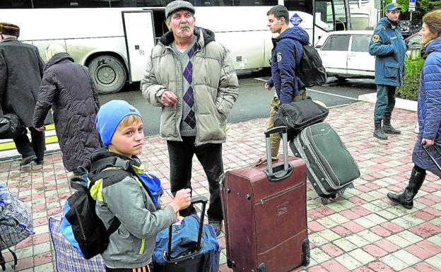 Civilians evacuated from Kherson wait at the Dzhankoi station in Crimea to be sent to the interior of Russia.