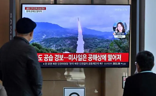 Koreans watch the news about a North Korean missile launch on television. 