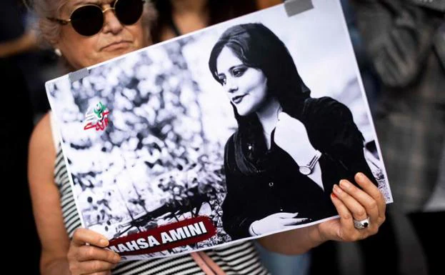 A woman protests the death of Mahsa Amini in Paris, France. 