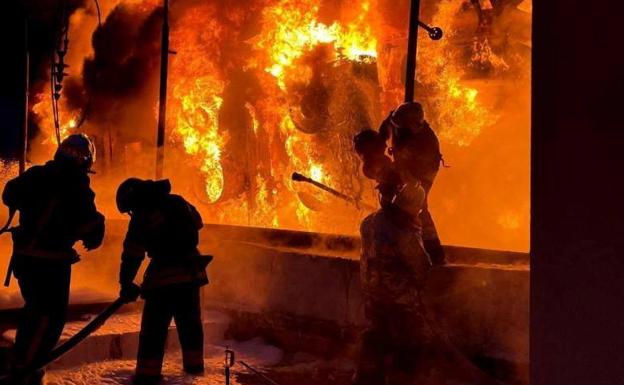 Firefighters work to put out the flames after a Russian bombardment in Odessa.