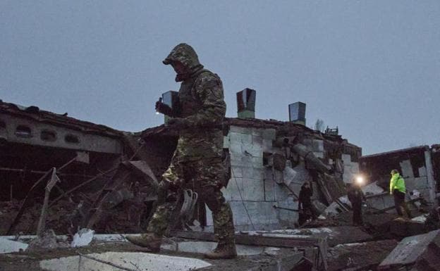 Rescue teams examine the ruins of a building after a Russian attack on Kherson.