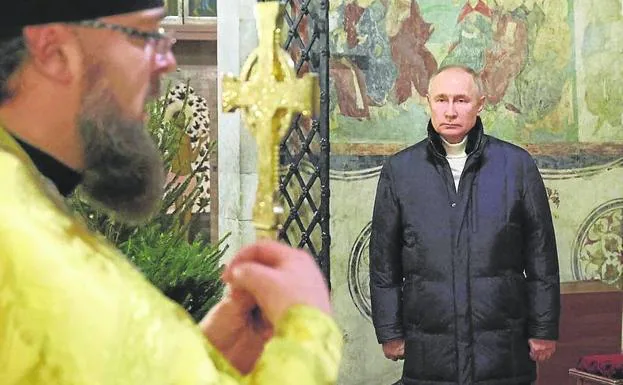Russian President Vladimir Putin attends an Orthodox Christmas mass in Moscow. 