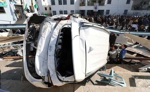 Palestinians look at a vandalized vehicle caused by an Israeli military raid in the Jenin refugee camp on Thursday.
